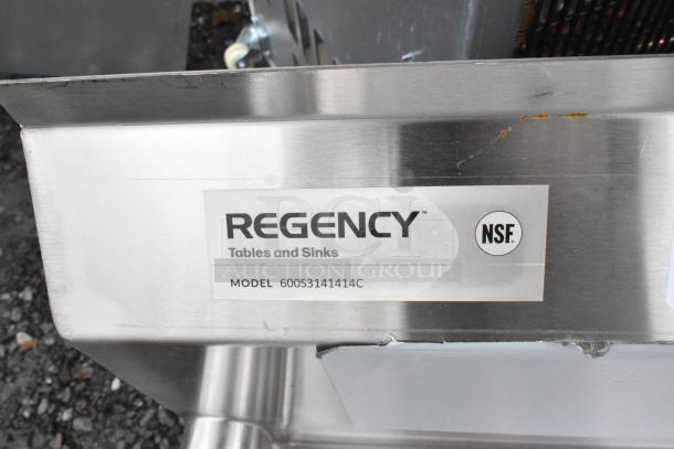 BRAND NEW Regency 600S3141414C stainless steel 3-bay L-shaped sink with dual drain boards and visible scratches. No legs.