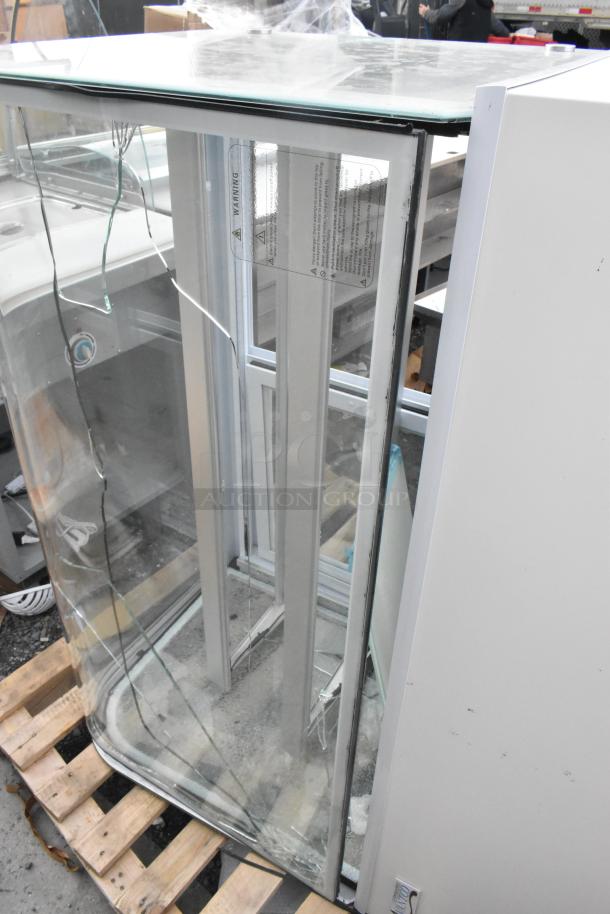 Brand new Avantco 193BC48HCW 48" refrigerated bakery display case, curved glass, white, 115 volts, glass damage visible.