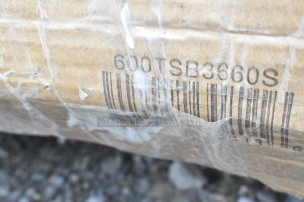 Barcode and label showing "600TSB3660S" on cardboard packaging, part of a new scratch and dent auction item set.