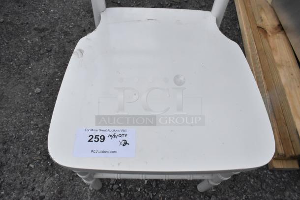 White Chiavari stackable banquet chair with visible minor scratches and dents. Auction tag reads "259" and "2 Times Your Bid."