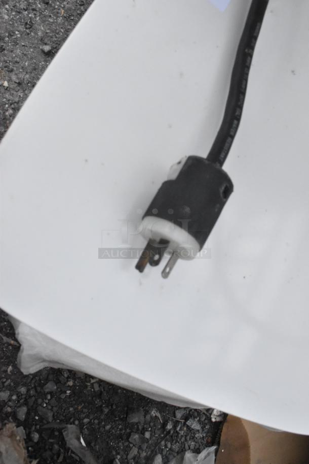 Close-up of a power plug for the Hoshizaki DCM-500BAH Ice Maker, showing a three-prong configuration.