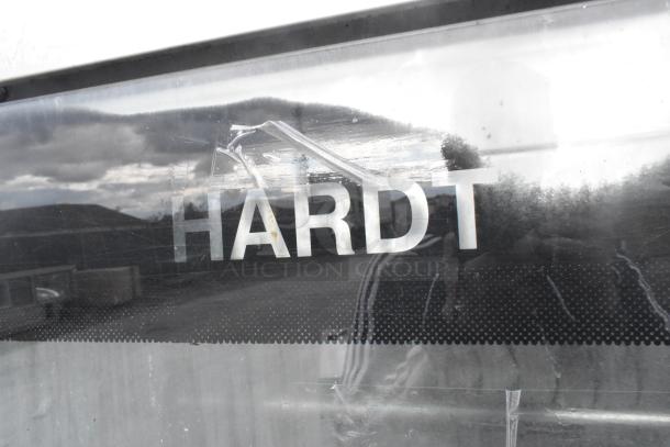 Hardt Inferno 4500 stainless steel rotisserie oven, natural gas powered, features skewers, metal legs, commercial casters.