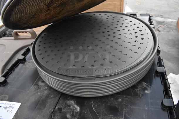 18 new scratch and dent round metal baking pans, perforated design, stacked on a surface, label indicates auction details.