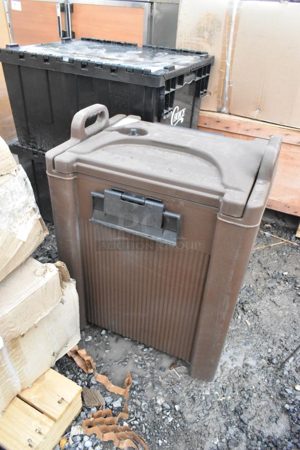 Brand new Carlisle XT10000 brown poly insulated beverage dispenser, scratch and dent condition, durable with secure lid.