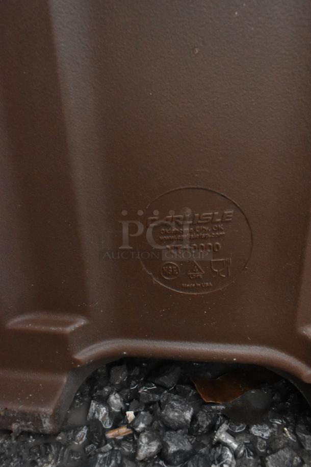 Brand new Carlisle XT10000 brown insulated beverage dispenser with minor scratches and dents, visible label markings.