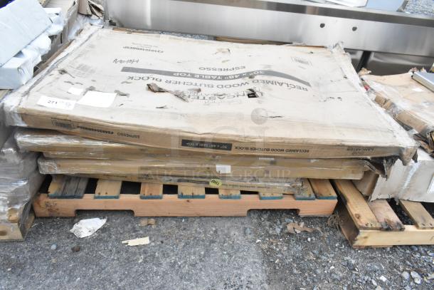 Seven brand new, scratch-and-dent Lancaster Table & Seating table tops on pallets; includes models 3493048BBESP, 427SD3636FH, and 1643048TFRMH.