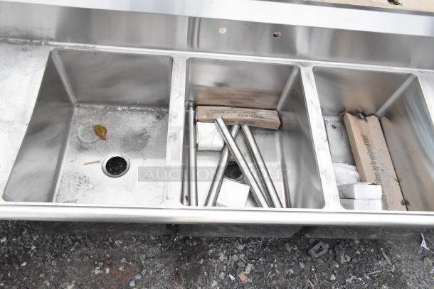 BRAND NEW SCRATCH AND DENT! Regency 600S31824224 stainless steel 3 bay sink with dual drain boards, visible scratches.