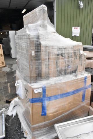 Pallet of 10 new scratch and dent items including Regency work tables, wrapped in plastic, visible labels and markings.