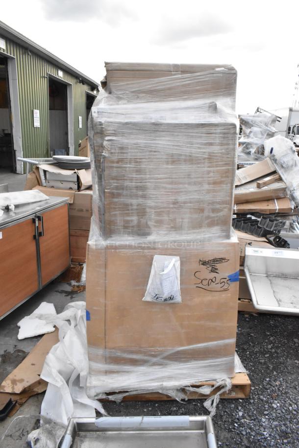 Pallet with 10 brand new scratch and dent items, including Regency work tables, wrapped in plastic for auction. Box labeled "SCD-55."