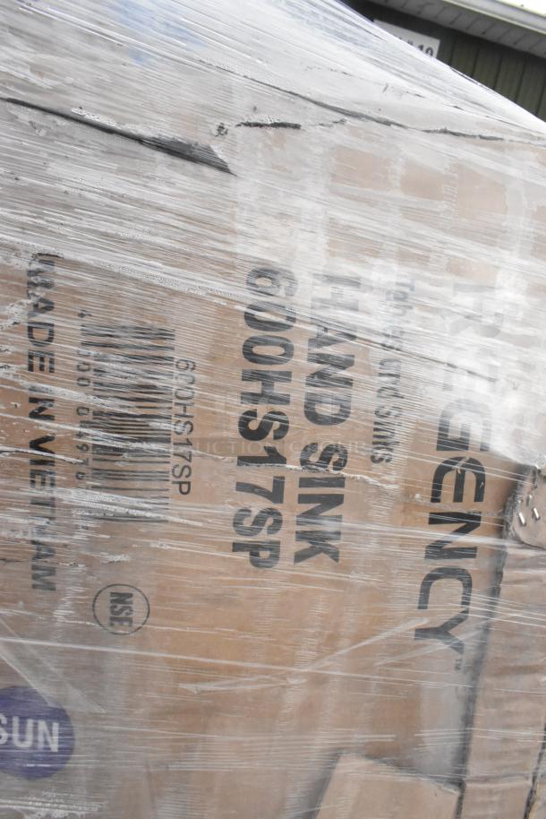 Pallet wrapped in plastic, revealing Regency brand markings, labeled "HAND SINK 600HS17SP." Mint condition scratch and dent items.