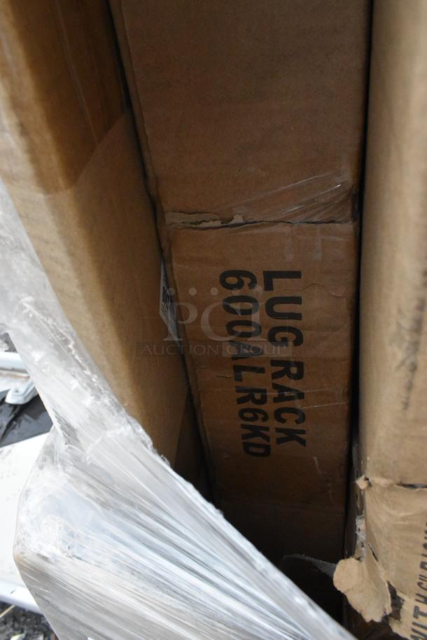 Boxes labeled "LUG RACK 600ALR6KD," wrapped in plastic, containing scratch and dent Regency work tables, new condition.