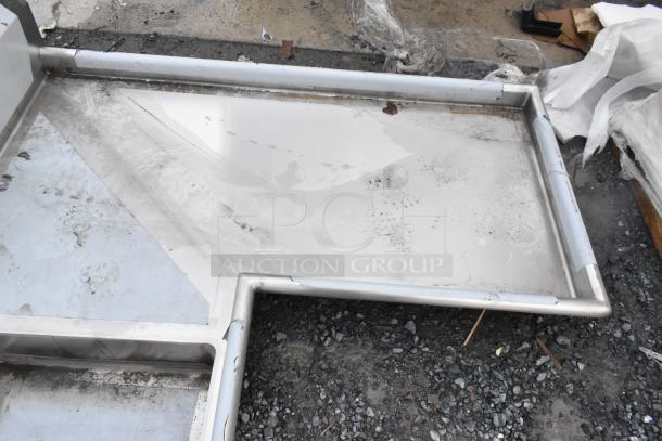 Brand new Regency 600DDTI60R 5' 16-gauge stainless steel soiled L-shape dishtable, no legs, some scratches visible.