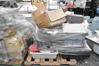 Lot of assorted items including metal fry baskets, poly bins, and bowls wrapped in plastic on a pallet. Box labeled "American Specialties, Inc."