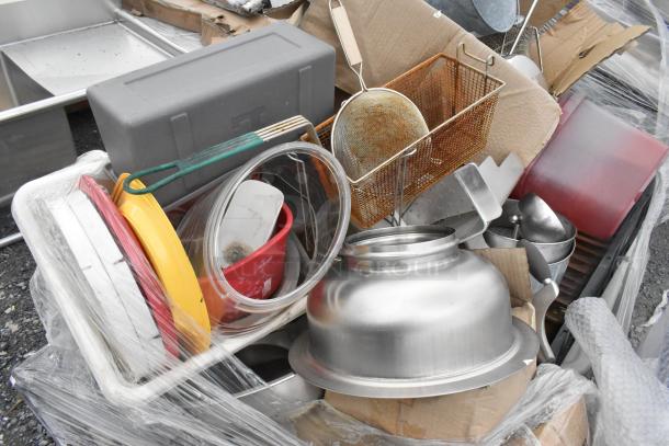 Lot of kitchen items including metal fry baskets, poly bins, bowls, and utensils in various conditions, wrapped in plastic.