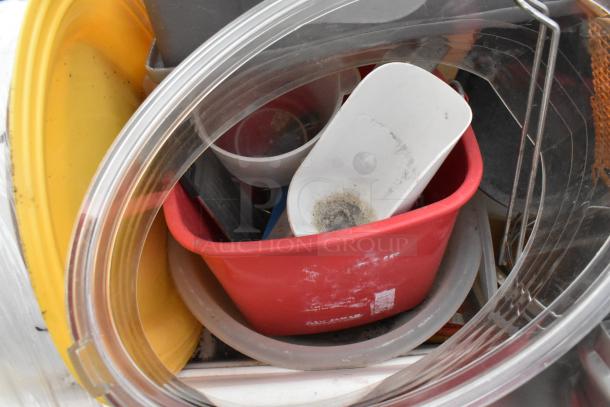 Lot of items including metal fry baskets, poly bins, and bowls in various colors and conditions. Ideal for multipurpose use.