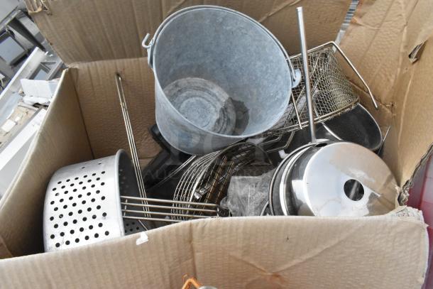 Cardboard box containing metal fry baskets, poly bins, and various bowls. Items appear in used condition, ideal for bulk purchase.