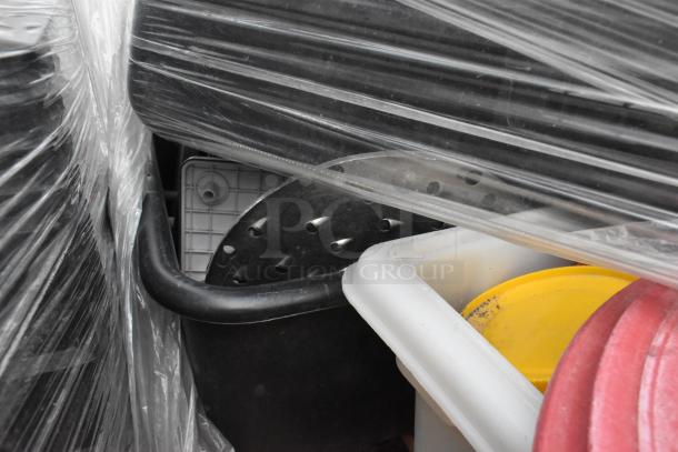 Lot of items including metal fry baskets, poly bins, and bowls wrapped in plastic. Appears in used condition.