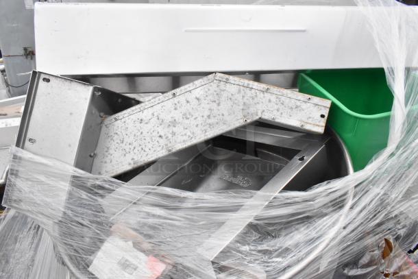 Lot including poly bins, poly lids, wire shelves, and metal parts. Items are wrapped in plastic. Mixed condition.