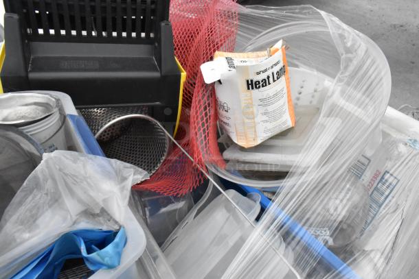 Lot of items including glassware, gas hose, and metal pieces, featuring a Shat-R-Shield Heat Lamp box, enclosed in plastic wrap.