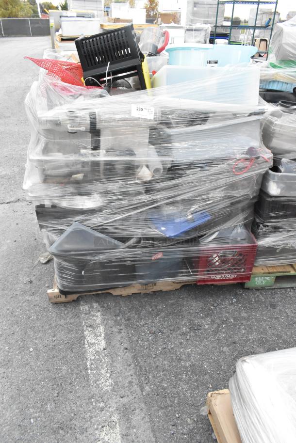 Lot of assorted items including glassware, gas hose, and metal pieces wrapped on a pallet. Mixed condition, bulk auction sale.