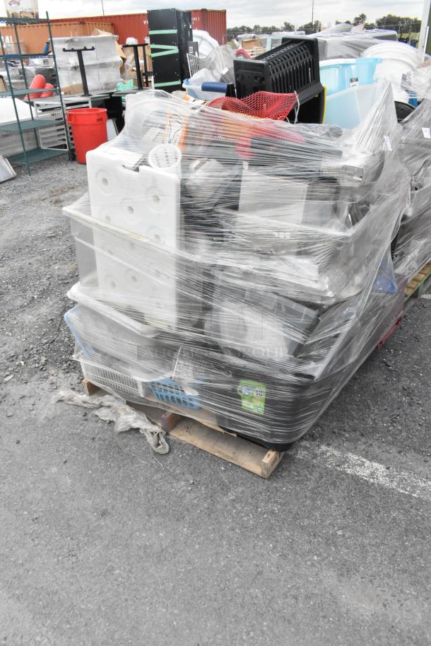 Lot of assorted items including glassware, gas hose, and metal pieces, wrapped on a pallet, ideal for bulk purchase.