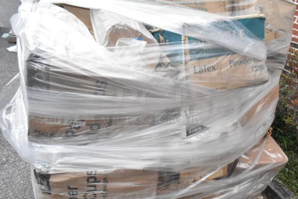 Pallet wrapped in plastic containing boxes of Visions plastic stemless wine glasses, Noble latex gloves, and paper cold cups.