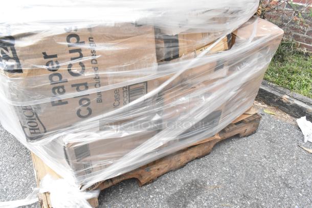 Shrink-wrapped pallet of assorted brand new scratch and dent items, including paper cold cups in labeled boxes.