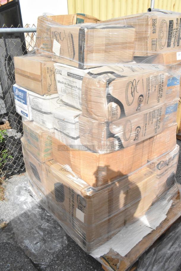 Shrink-wrapped pallet with new scratch-and-dent items, including ice bags, containers, and plastic spoons. Various brands visible.