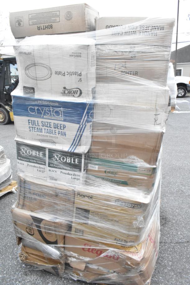 Large pallet wrapped with assorted boxed items including cold cups, containers, towels, and plates, labeled as scratch and dent.