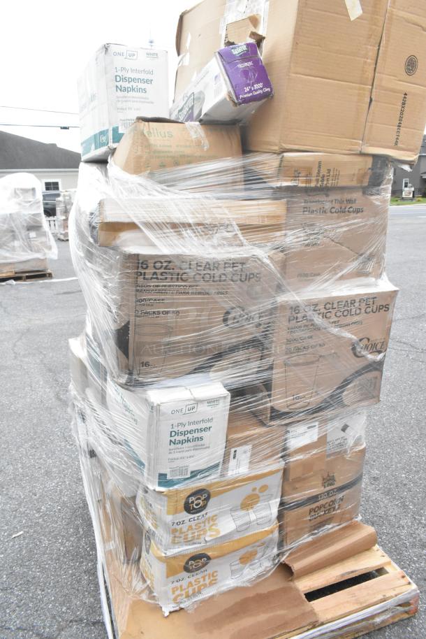 Pallet of assorted packaged items including napkins, plastic cups, and popcorn buckets. Items are shrink-wrapped.
