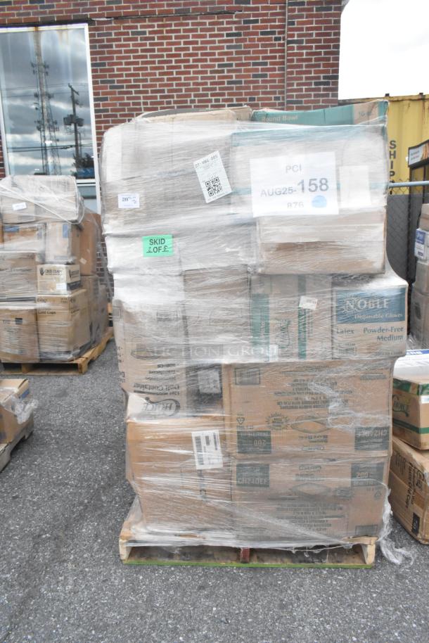 Pallet stacked with 27 brand new scratch and dent items, including paper towels, plates, containers, and gloves, wrapped in plastic.