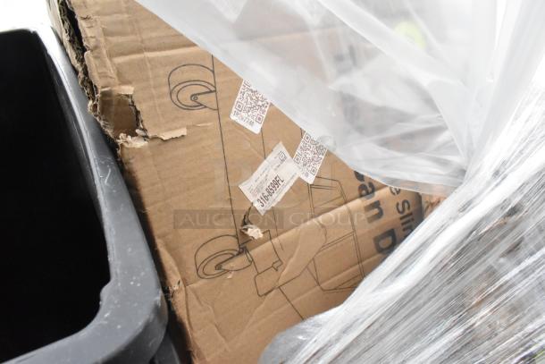 Damaged cardboard box showing QR codes and torn edges, containing Scratch and Dent auction items.