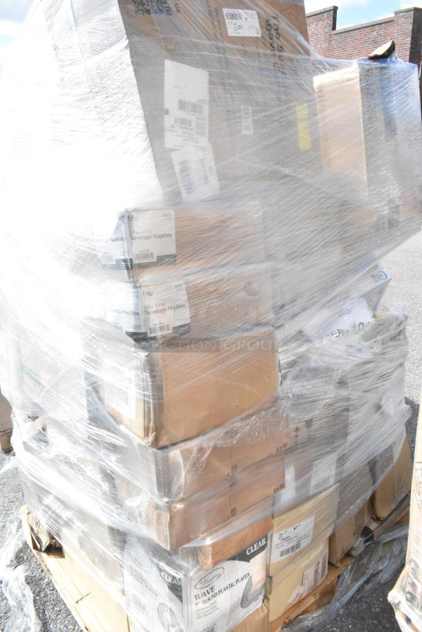 Pallet of 36 brand new scratch and dent items wrapped in plastic, including boxes labeled with beverage napkins and plastic plates.