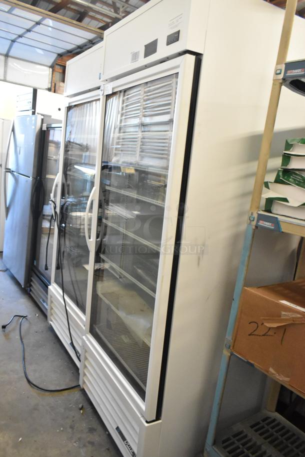 2021 True TSCI-600R-G-PH single door reach-in cooler with glass front and poly coated racks, 115V, 1 phase.