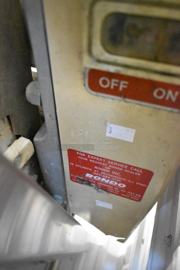 Rondo Seewer commercial dough sheeter, reversible, no legs, visible service label, worn condition.