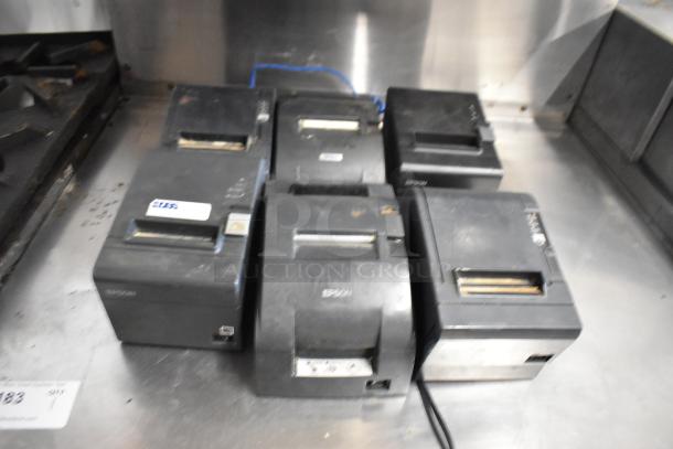 Six Epson receipt printers, models M129C, M188B, TM-T20II, showing signs of use. Auction lot includes all shown units.