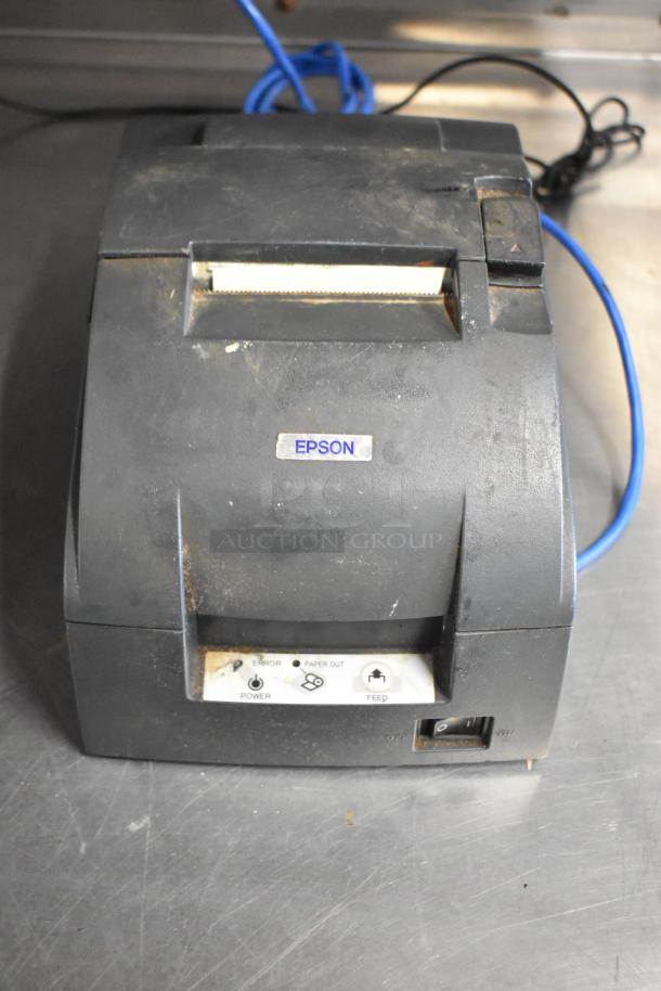 Epson receipt printer, model M129C, visible wear, includes power and feed buttons, suitable for small business operations.