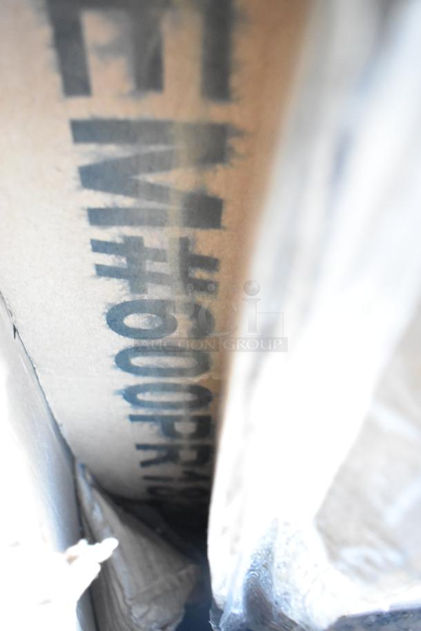 Box labeled with "600GT25" indicates a Regency 50 lb. 25 GPM grease trap included in auction of 10 brand new scratch and dent items.