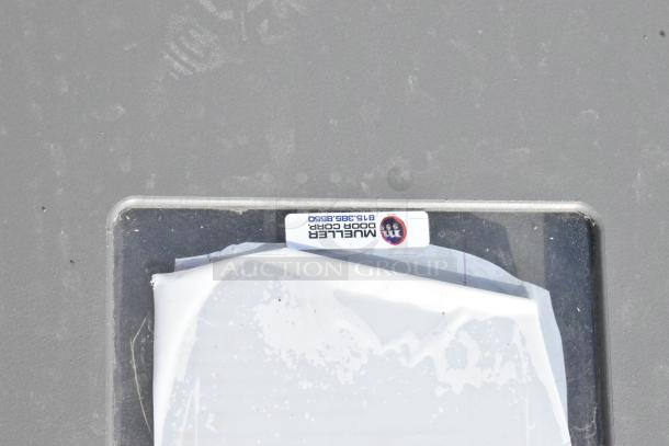 Mueller Door Corp swinging kitchen doors, visible label with brand name and contact number, new condition.