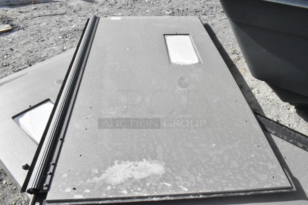 2 Mueller Door Corp swinging kitchen doors, gray, used condition. Features windows and hinges, sold at 2 times your bid.