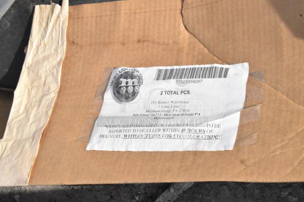 Cardboard box with taped label showing two total pieces. Marked for Remco Warehouse, Mechanicsburg. Includes shelving, 24"x75" door.