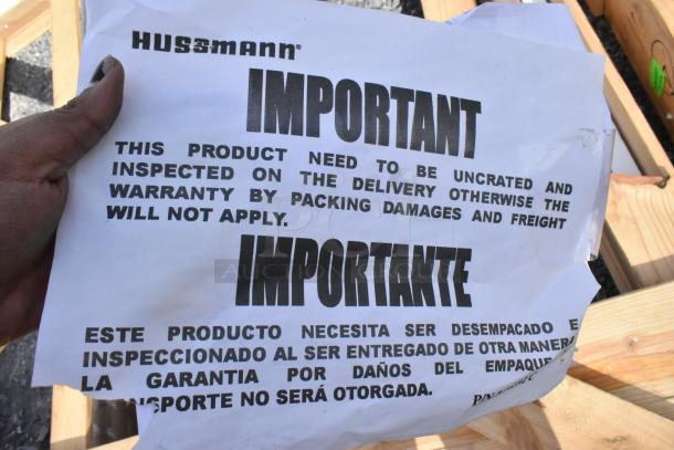 Alt text: Hussmann inspection notice, emphasizing immediate uncrating to prevent warranty void.