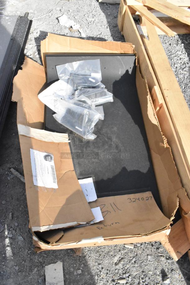 Lot of pieces including shelving and a 24"x75" door, brand new with minor scratches and dents, in open packaging.