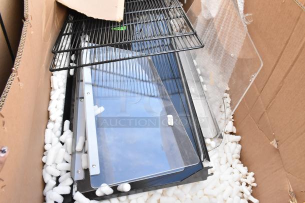 Lot of brand new scratch and dent pieces, including shelving and 24"x75" door, in a cardboard box with packing materials.