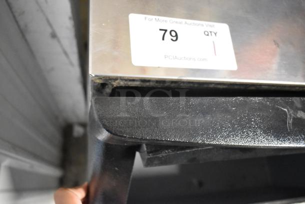 Manitowoc QY0134A stainless steel ice machine, self-contained, commercial use, visible sign of wear, auction label with lot 79.