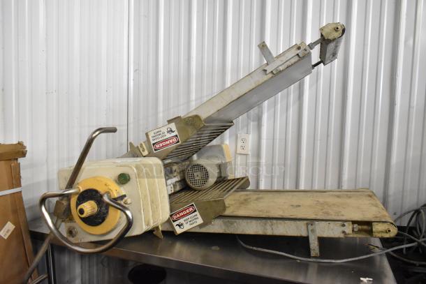 Rondo Seewer metal reversible dough sheeter, floor style, no legs. 208/240 volts. Labels indicate safety warnings.