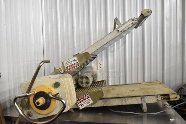 Rondo Seewer metal commercial floor reversible dough sheeter, missing legs, 208/240 volts, visible wear, "Danger" labels present.