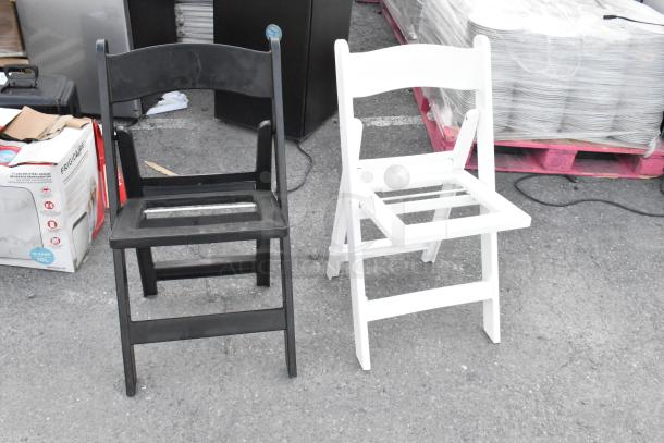Two folding banquet chairs, one black and one white, sturdy frame, outdoor setting, available in a lot of 39.
