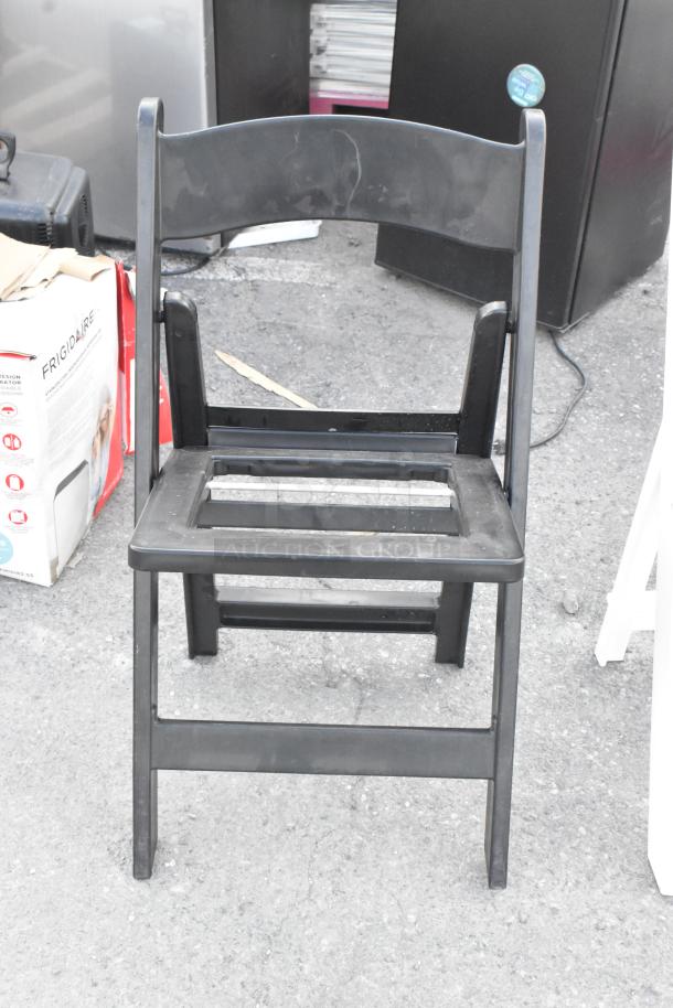 Black folding banquet chair, plastic, fair condition. Auction lot includes 39 chairs.