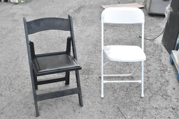 Black and white folding banquet chairs on pavement. Auction includes 106 similar chairs. Condition appears used.